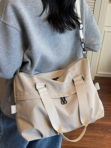 Large capacity beige nylon tote bag with black strap for commuting and gym use