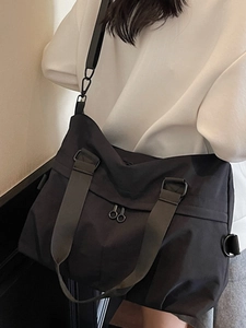 Minimalist black large capacity sports tote bag with adjustable strap for travel and commute