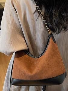 Retro brown suede hobo shoulder bag with black leather trim and chain strap details