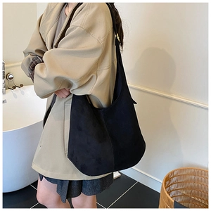 Detail of black large hobo bag with soft matte suede texture and adjustable metal buckle
