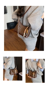 Detail of a brown woven crossbody bag with silver chain and bohemian beaded charms