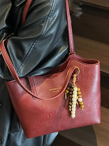 Deep red vintage tote bag with bohemian wood bead charm and adjustable shoulder straps