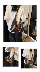 Detail of dark brown glossy hobo bag with rabbit charm shown in a lifestyle indoor setting