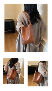 Détail du sac cabas en cuir marron montrant la texture souple et la large bandoulière