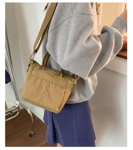Khaki nylon square crossbody bag shown with adjustable wide strap for daily commute
