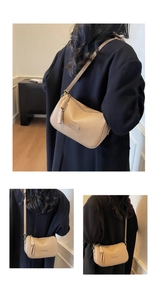 Détail du sac beige en cuir grainé avec plaque métallique fashion et fermeture éclair