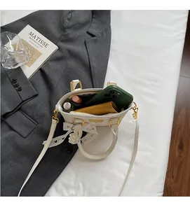 Internal view of beige plaid bucket bag showing space for phone and cosmetics