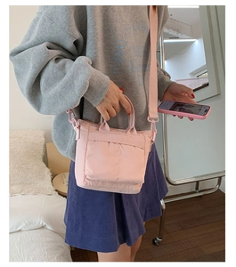 Pink canvas tote bag shown as a crossbody bag in a cozy home setting macro view