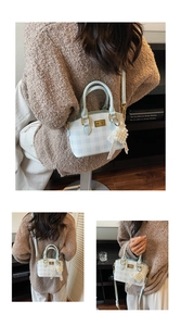 Detail of light blue plaid mini bag with heart pearl charm and golden twist lock clasp