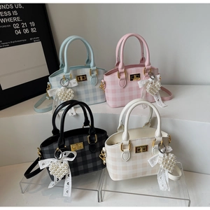 Detail showing four colors of plaid handbags with pearl heart charms and lace ribbons