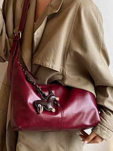 Fashionable dark red leather hobo bucket bag with a small horse charm for women