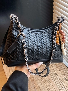 Handheld black woven underarm bag with silver chain strap and wooden bead charm