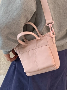 Pink minimalist canvas tote bag with dual front pockets for daily casual use