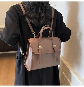 Brown vintage faux leather backpack featuring classic flap and gold metal buckle details