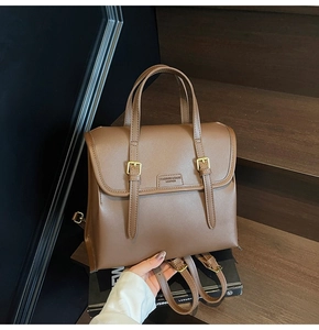 Detail showing high-quality brown leather texture and buckle on vintage convertible backpack