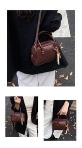 Vue détaillée d'un sac Boston en cuir marron avec ornement de perles et bandoulière