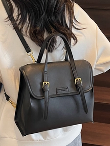 Vintage black leather tote bag with gold buckles and convertible multi-way shoulder straps