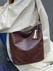 Fashionable dark brown woven bucket bag with wood bead tassel and adjustable strap