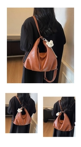 Detail of caramel large hobo bag with pleated soft PU leather and bear charm accessory