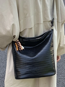 Fashionable black woven bucket bag with wood bead tassel and adjustable strap