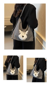 Detail showing the adjustable thin strap and grey denim fabric of the cartoon shoulder bag