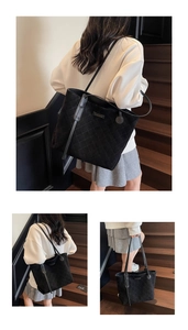 Detail of black quilted tote bag showing suede texture and fashion metal nameplate