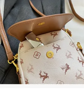 Détail du sac bandoulière beige chic avec poche avant pour rouge à lèvres et rabat magnétique