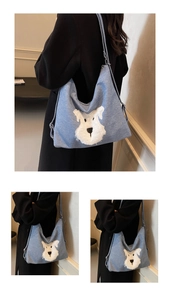 Close-up of blue denim tote bag featuring a 3D white plush puppy character design
