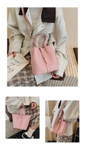 Detail of pink lychee leather bucket bag showing texture, handle and adjustable strap