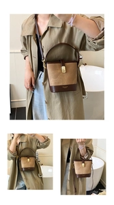 Detail showing the suede texture bucket bag with contrast leather trim and golden metal clasp