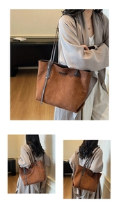 Detailed view of brown quilted suede tote bag with leather straps and metal hardware