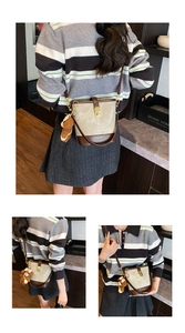 Detail view of retro beige bucket bag with brown leather base and cute bear charm