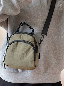 Olive green shell nylon crossbody bag with woven handles and adjustable strap for women