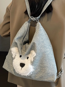Light blue denim backpack with cute plush dog character for women shown on model