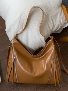 Caramel brown large capacity tote bag with dual zippers and long fringe tassels