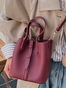 Burgundy lychee grain leather bucket bag with top handle and crossbody strap for women