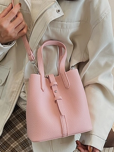 Pink lychee grain leather bucket bag with top handle and adjustable shoulder strap