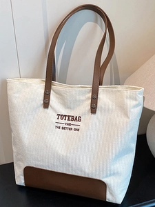 Borsa tote minimalista in velluto a coste beige con manici in pelle marrone e ricamo