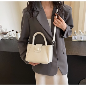 Lifestyle shot of white litchi leather bucket bag with silver hardware for daily wear