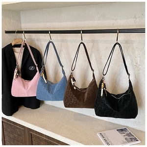 Detail view of large leopard print tote bags in four colors with vintage bead charms