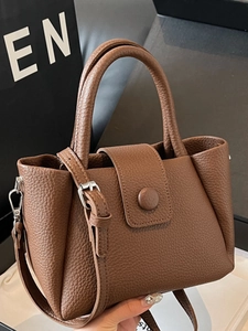 Brown litchi grain leather bucket bag with top handles and a detachable shoulder strap