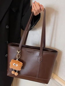 Sac fourre-tout en cuir marron foncé avec surpiqûres blanches et breloque peluche