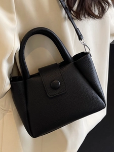 Fashionable black pebbled leather bucket bag with top handles and shoulder strap for women