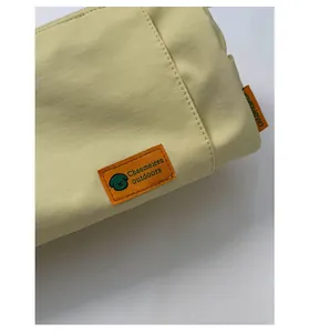 Detail of tear-resistant oxford fabric texture with orange brand label on travel bag