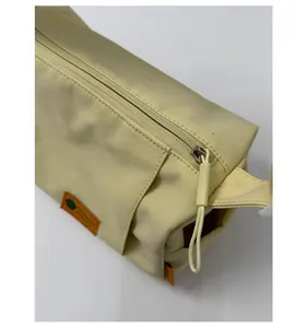 Detail of smooth yellow fabric texture and matching zipper on rectangular bag