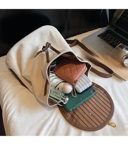 Interior view of large beige suede backpack showing tablet and daily essentials storage