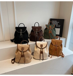 Detailed view showing six vintage colors of matte backpacks with metal buckles and drawstrings