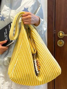 Chic yellow and white striped knit shoulder bag with colorful wooden bead tassels