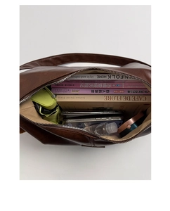 Detail shot showing the large capacity of the dark brown matte shoulder bag with essentials