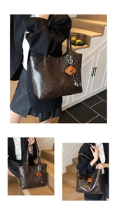 Detail of vintage dark brown leather tote bag with plush dog charm and woven tassels